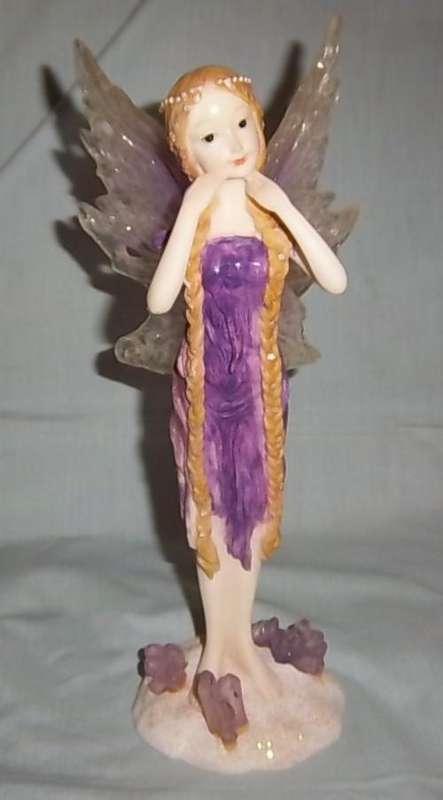 A FAIRY WITH LONG HAIR AND A PURPLE DRESS