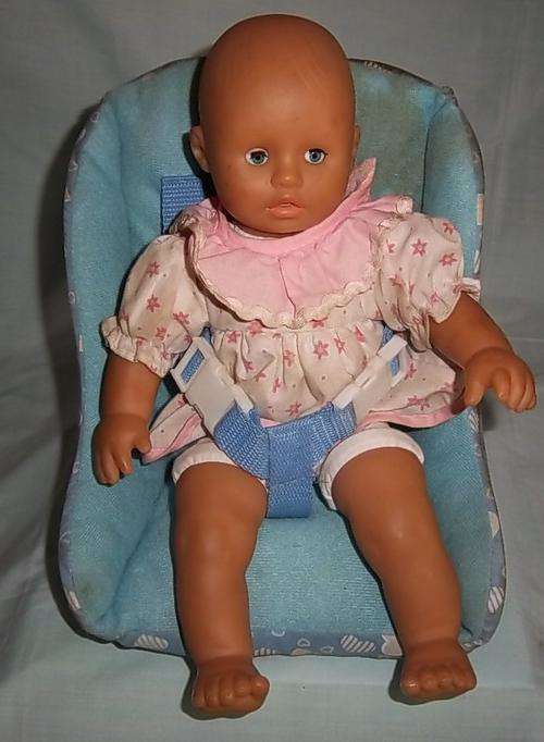 A DOLL IN A BABY SEAT BY SIMBA TOYS