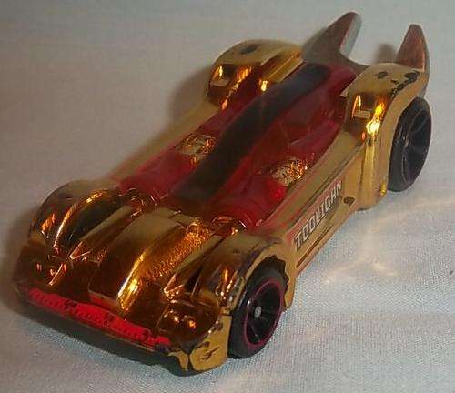 A GOLD AND RED SPANNER TOOLIGAN CAR BY HOTWHEELS