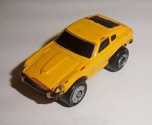 A YELLOW MICRO MACHINES CAR