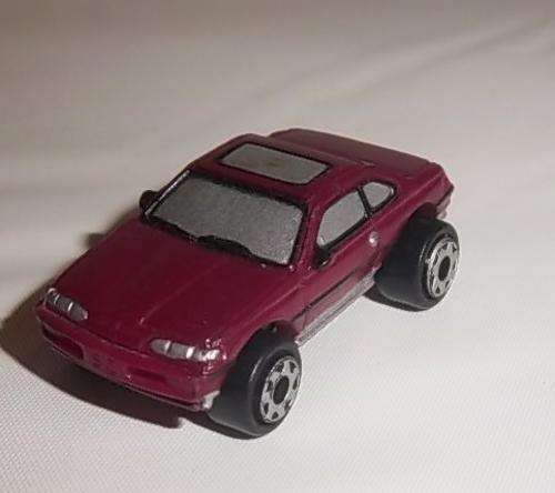 A 1994 MAROON CAR BY MICRO MACHINES