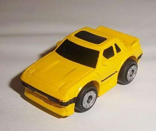 A YELLOW CAR WITH BLACK WINDOWS AND SUNROOF BY MICRO MACHINES