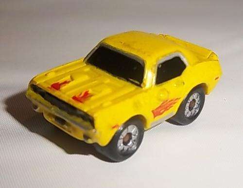 A YELLOW CAR WITH FLAME DECALS BY MICRO MACHINES