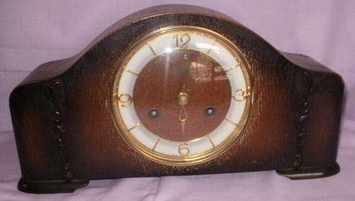 A SMALL SCHATZ MANTLE CLOCK WITH PAPERS