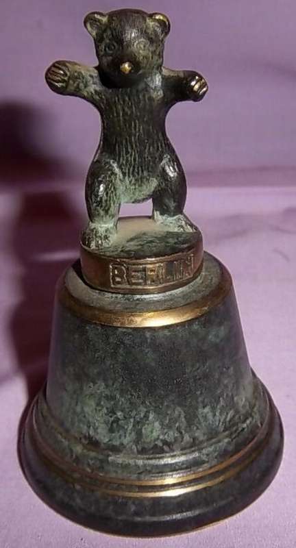 A HEAVY METAL BELL WITH A BEAR MOTIVE FROM BERLIN
