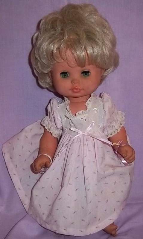 A WET HERSELF DOLL IN A PINK DRESS