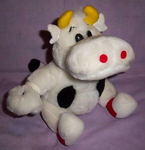 A COW WITH RED AND WHITE SHOES