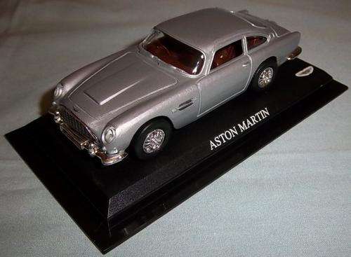 A SILVER DIE CAST ASTON MARTIN MODEL ON A STAND