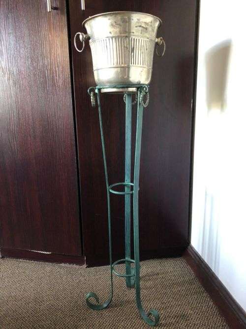 ICE BUCKET ON PAINTED WRAUGHT IRON STAND-THE BUCKET IS PLATED SILVER WITH A DIAMETER OF 24 CM AT THE