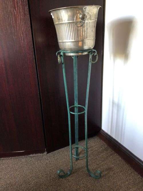 ICE BUCKET ON PAINTED WRAUGHT IRON STAND-THE BUCKET IS PLATED SILVER WITH A DIAMETER OF 24 CM AT THE