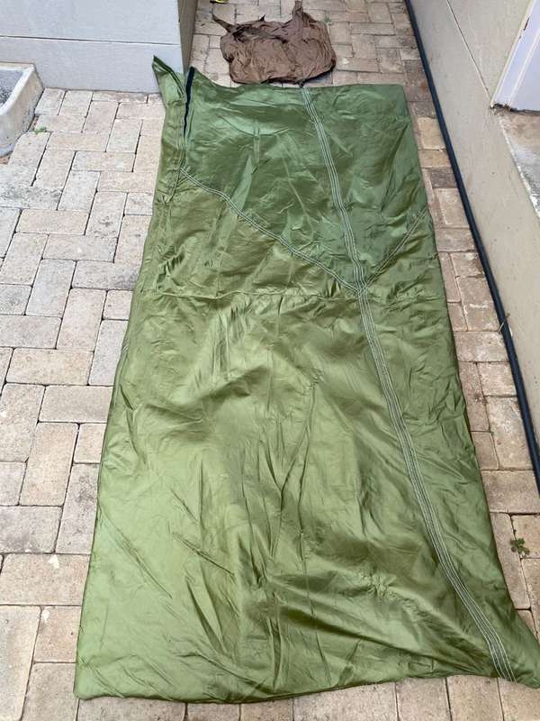 MILITARY ISSUE SLEEPING BAG-LOOKS LIKE PARACHUTE MATERIAL,WITH VELCRO ON THE ONE SIDE-COMES WITH CO