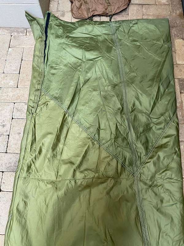 MILITARY ISSUE SLEEPING BAG-LOOKS LIKE PARACHUTE MATERIAL,WITH VELCRO ON THE ONE SIDE-COMES WITH CO