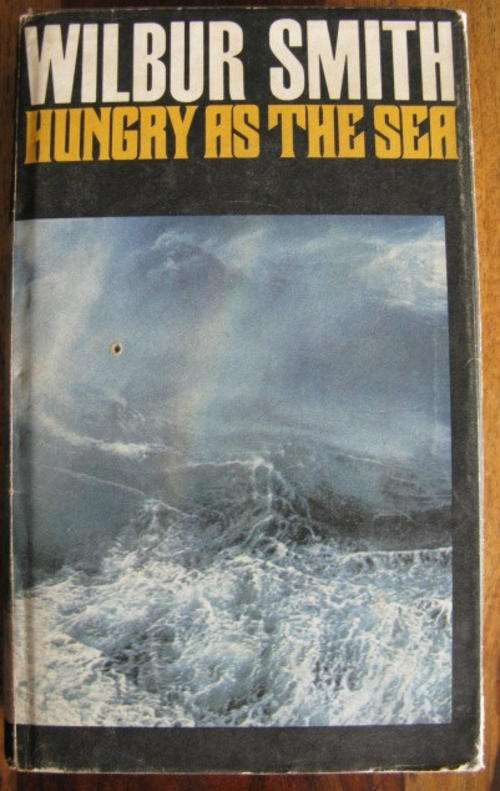 WILBUR SMITH - HUNGRY AS THE SEA.  1ST EDITION PUBLISHED 1978  REPRINT 1978