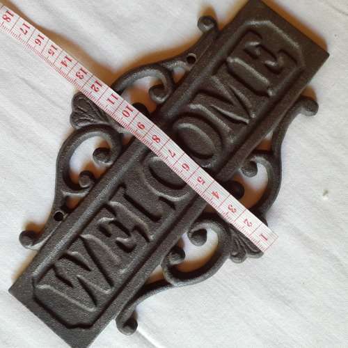Cast Iron `WECOME` sign.