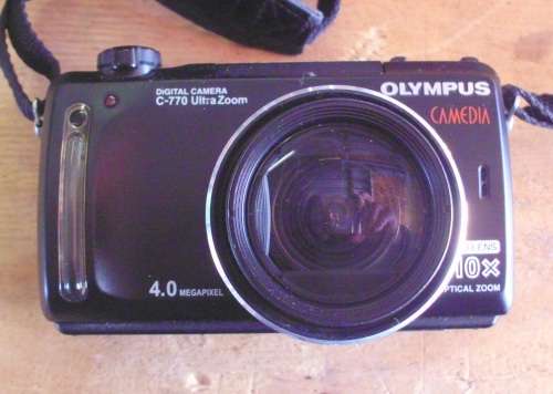 Camera Olympus with charger and battery for spares.