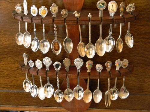17 Collector spoons around the world with rack and 7 without badges. Total 24.