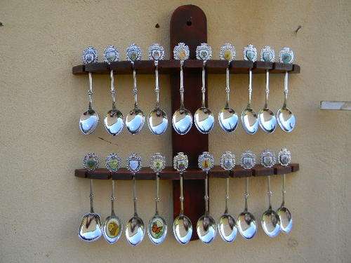 20  chrome collector spoons of  S. A. places in excellent condition with rack.See list of names