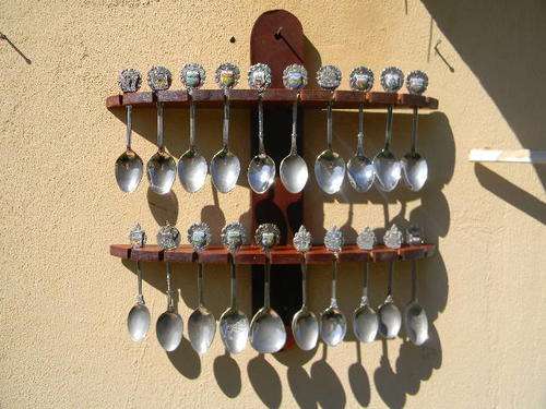 20 Collectable spoons,  of SA with rack .som with markings at the back.