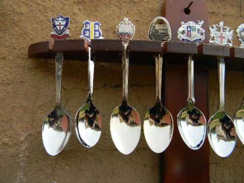 20 Collectable spoons of around the world in excellent condition with rack .