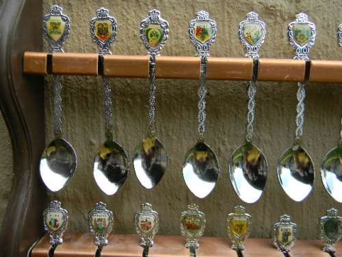 36 Souvenir  spoons as per pictures 12 sugar +12 with inlays spoons in good condition with free rack