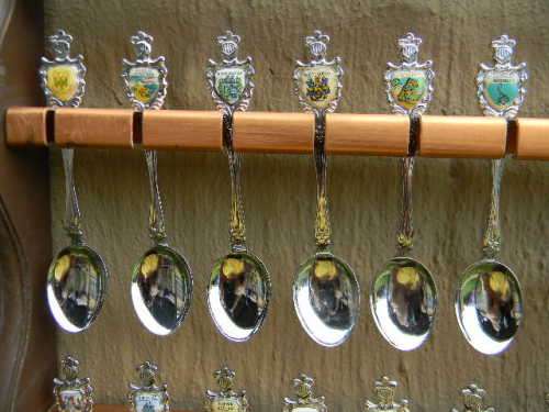 36 Souvenir  spoons as per pictures 12 sugar +12 with inlays spoons in good condition with free rack