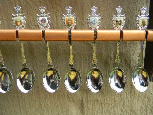 36 Souvenir  spoons as per pictures 12 sugar +12 with inlays spoons in good condition with free rack