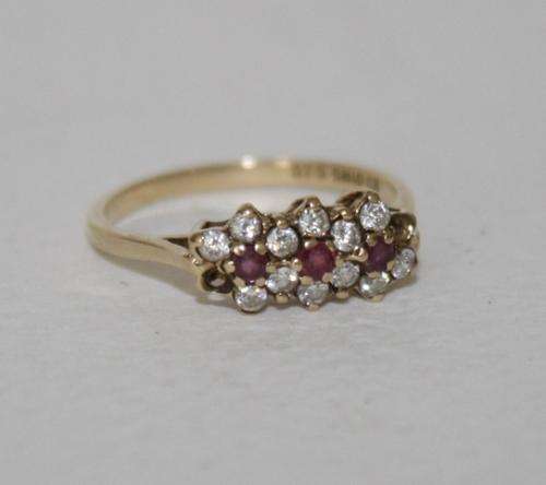 9ct Gold ring set with CZ and Red Garnets...Total Weight..1.6 Grams.