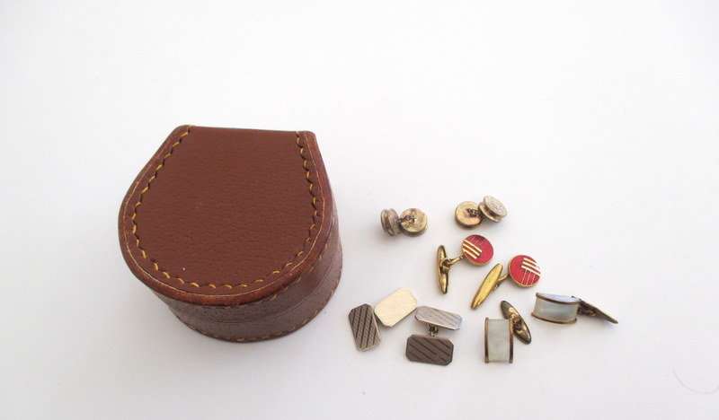 A cufflink box with cufflinks including a trench art pair made from bullets