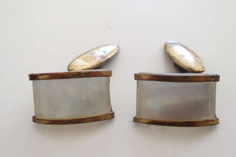 A cufflink box with cufflinks including a trench art pair made from bullets
