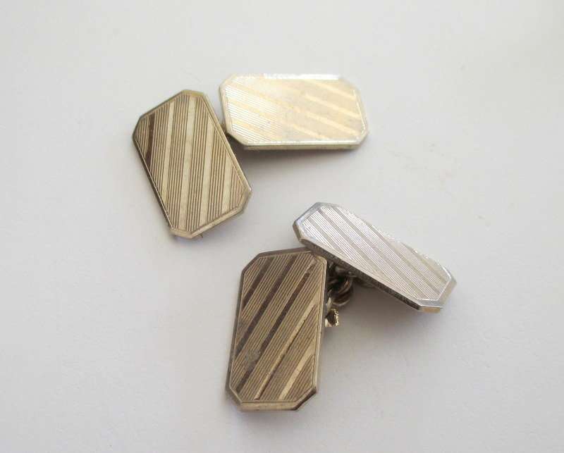 A cufflink box with cufflinks including a trench art pair made from bullets