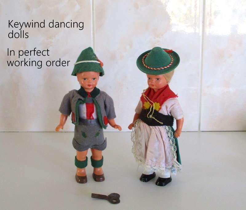 A PAIR OF VINTAGE KEY WIND DANCING DOLLS IN PERFECT WORKING ORDER