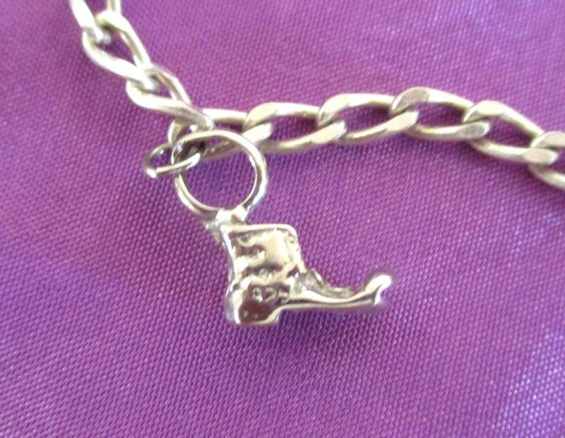 A SOLID SILVER CHARM BRACELET WITH EXTRA LARGER CHARMS