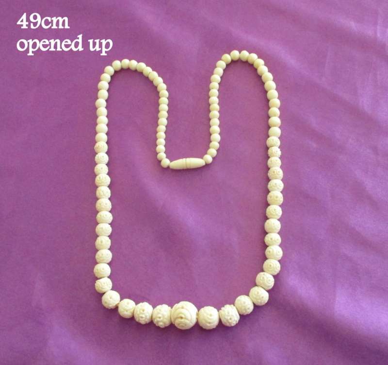 A STERLING SILVER BONE NECKLACE AND A CARVED BEADED BONE NECKLACE
