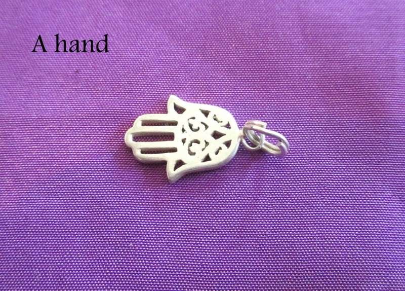 A SOLID SILVER LOCKET FOR A CHARM BRACELET AND 7 SOLID SILVER CHARMS