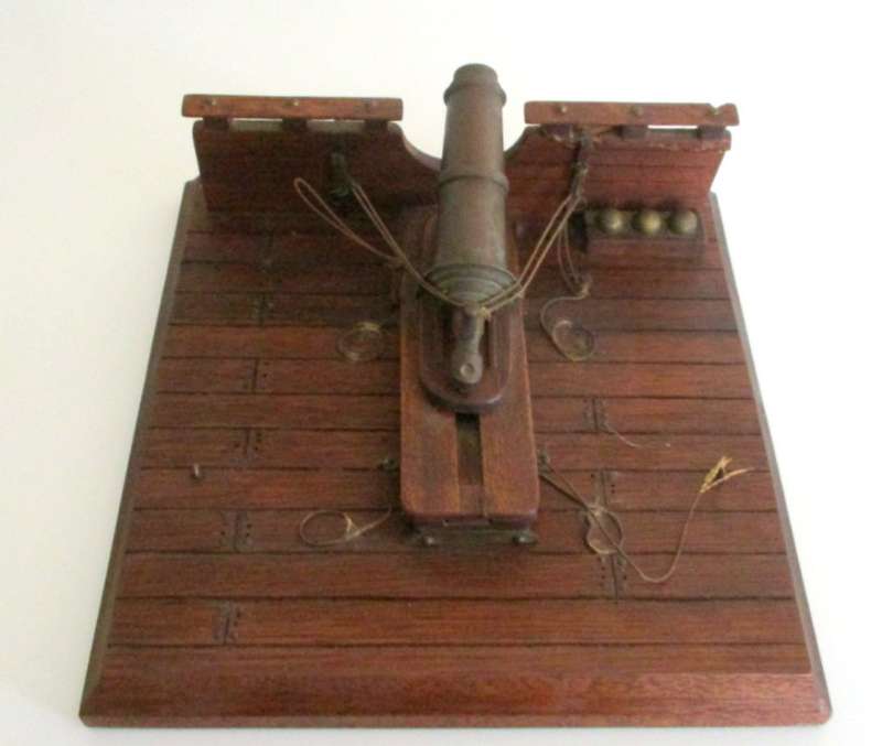 A WOOD AND BRASS REPLICA CANON