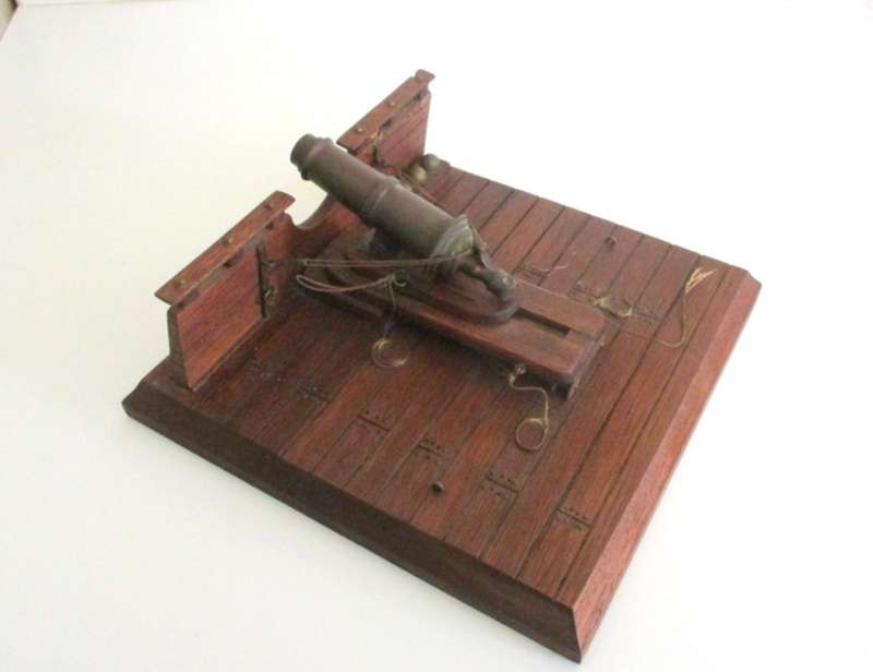 A WOOD AND BRASS REPLICA CANON