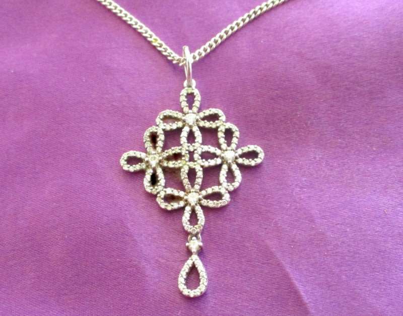 A SOLID SILVER PENDANT ON A SOLID SILVER CHAIN--PRETTY
