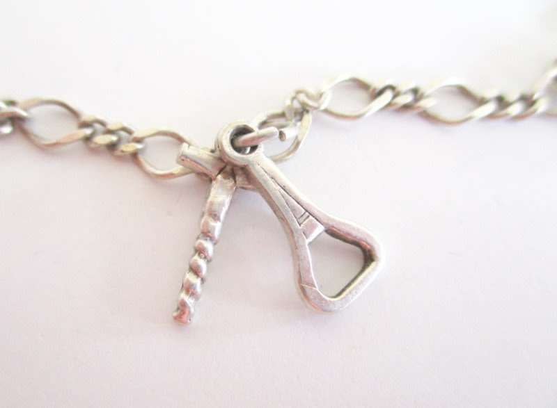 A SOLID SILVER CHARM BRACELET