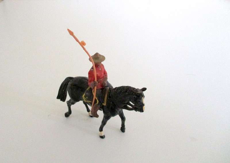A VINTAGE LEAD CANADIAN MOUNTED POLICEMAN AND 2 LEAD DWARFS