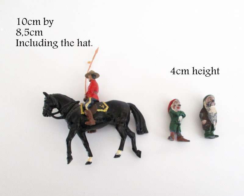 A VINTAGE LEAD CANADIAN MOUNTED POLICEMAN AND 2 LEAD DWARFS