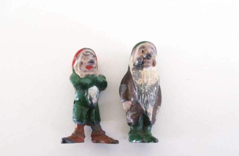 A VINTAGE LEAD CANADIAN MOUNTED POLICEMAN AND 2 LEAD DWARFS