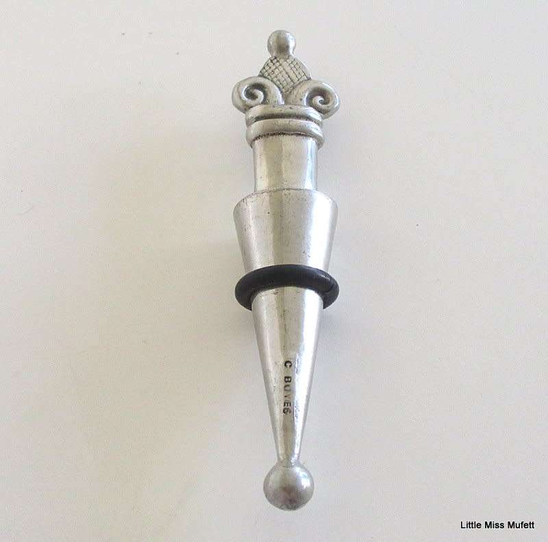 A CARROL BOYES WINE STOPPER WITH ORIGINAL RUBBER RING