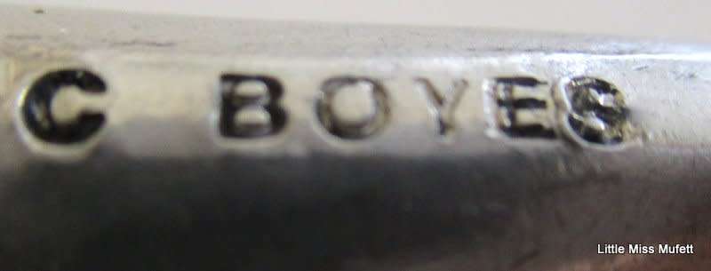 A CARROL BOYES WINE STOPPER WITH ORIGINAL RUBBER RING