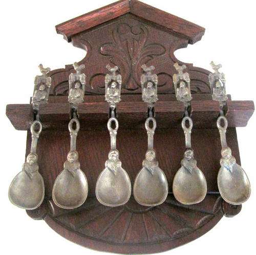 A SET OF SIX APOSTLE/ANNOINTING SPOONS PROBABLY VICTORIAN ERA ON A RACK