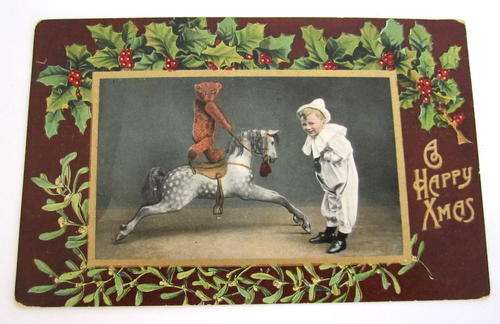 AN ANTIQUE POSTCARD OF A CHILD AND HIS BEAR