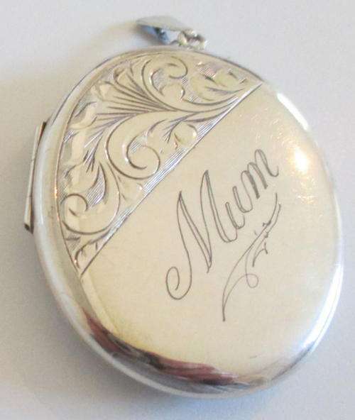 A LARGE HALLMARKED SILVER LOCKET
