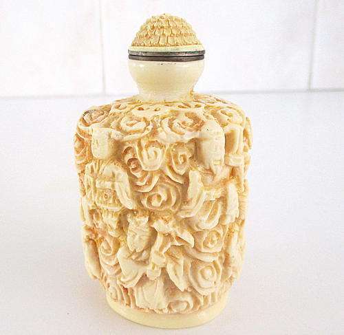 AN EMBOSSED ORIENTAL PERFUME BOTTLE