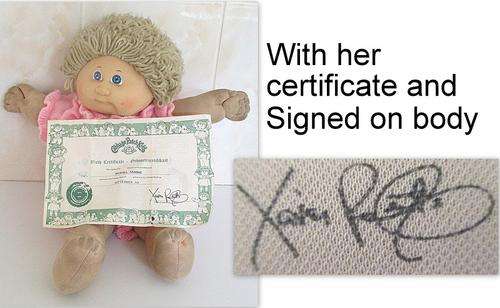 A CABBAGE PATCH DOLL WITH HER CERTIFICATE 1982