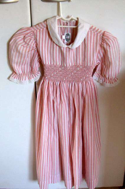 A CHILDS 20 YEAR OLD SMOCKED COTTON DRESS --HOME SEWN.