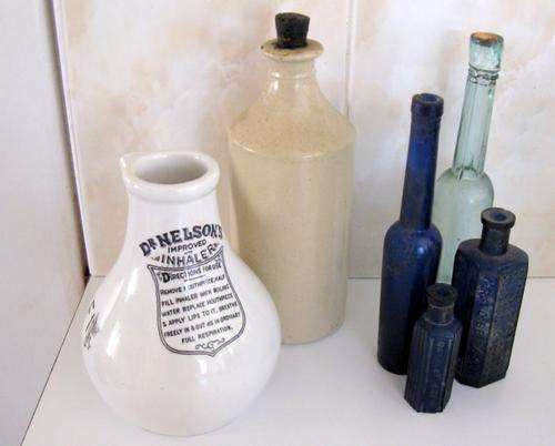 AN ANTIQUE INHALER AND BOTTLES